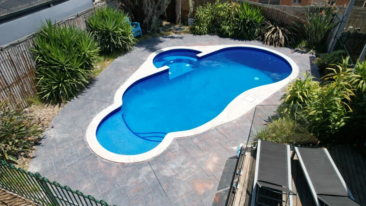 Pool interior resurfacing renovation — fully restored pool ready to swim