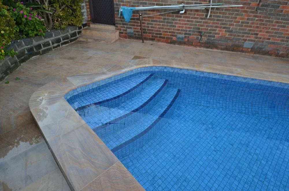 Fully tiled swimming pool renovation in Melbourne — tiled steps and interior