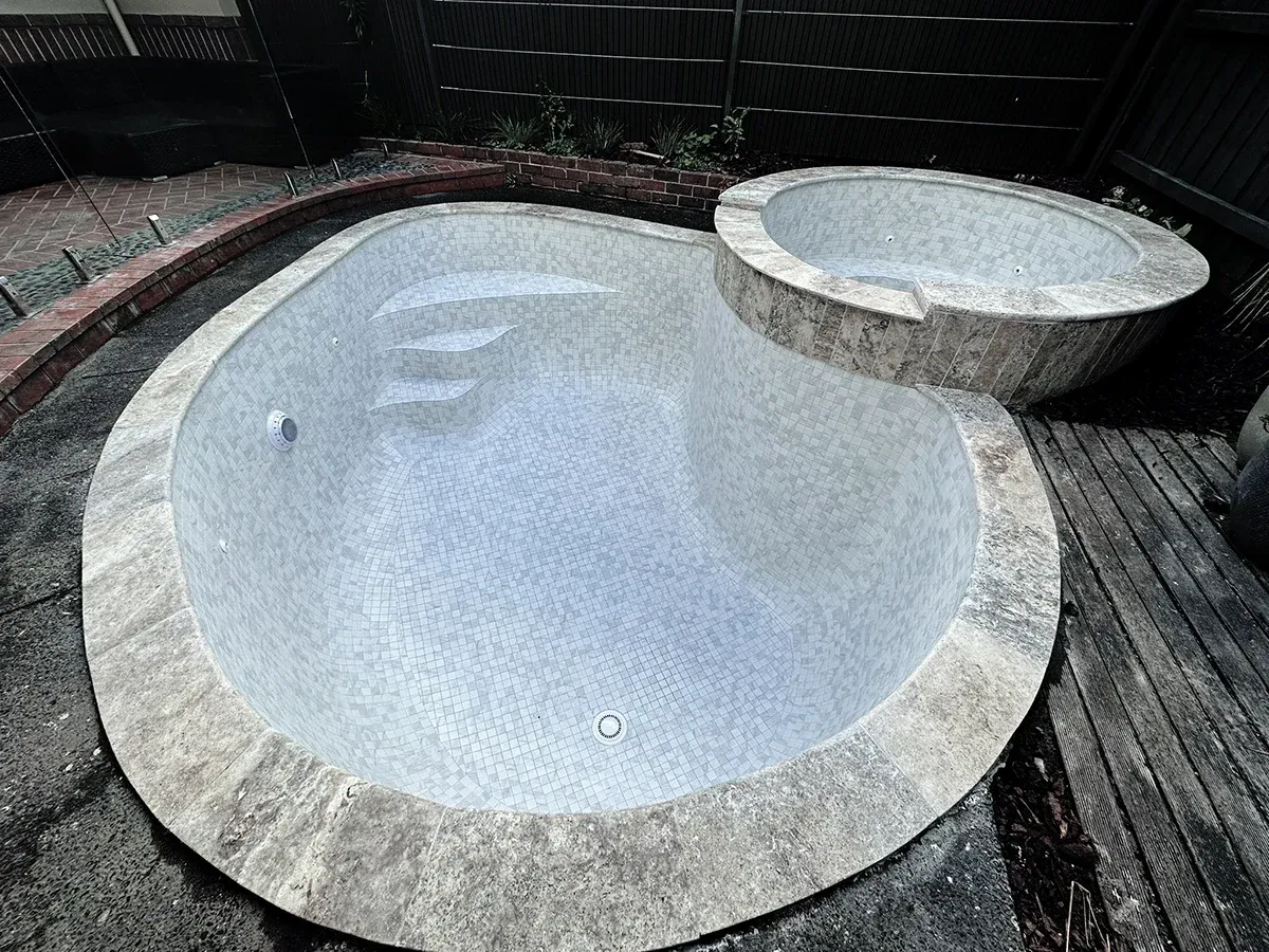Alphington pool and spa tiling renovation — fully tiled with Carrara tiles