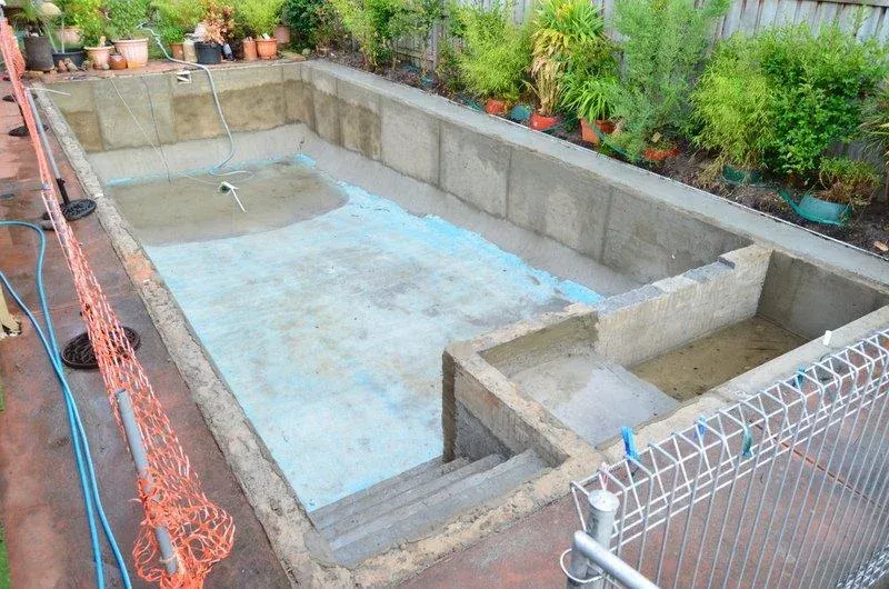 Fully tiled swimming pool renovation in Melbourne — completed beside garden bed