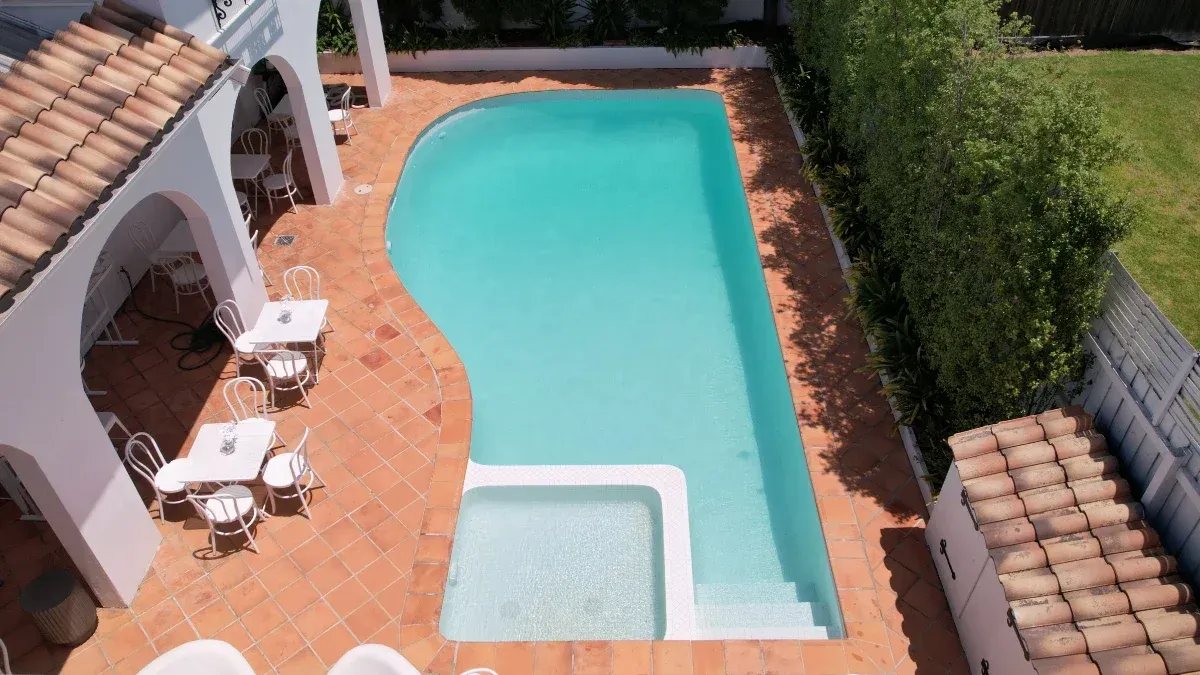 Fully tiled pool renovation in Brighton, Melbourne Bayside — white tiles with clear blue water