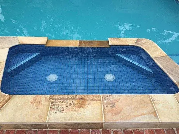 Pool tile resurfacing — fully tiled spa and pool after renovation